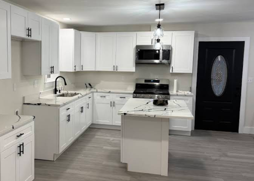 White shaker cabinet kitchen remodel with waterfall-edge island - UST Kitchen & Bath project