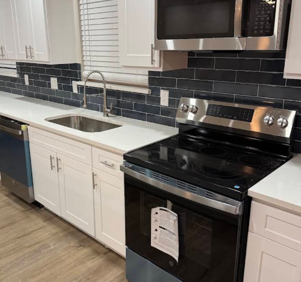 White cabinets with navy subway tile backsplash kitchen remodel - UST Kitchen & Bath project